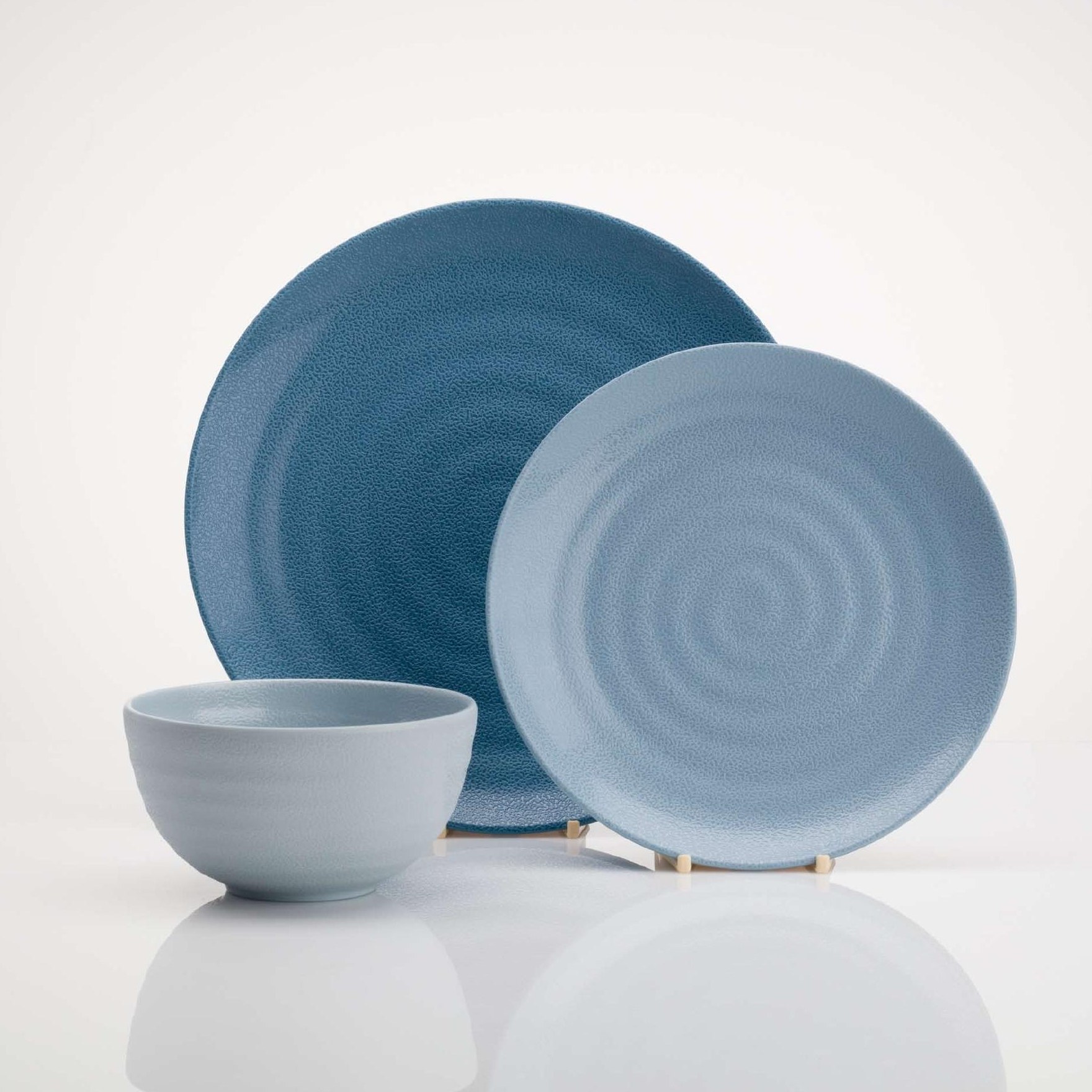 Two-tone blue plates with a matching bowl