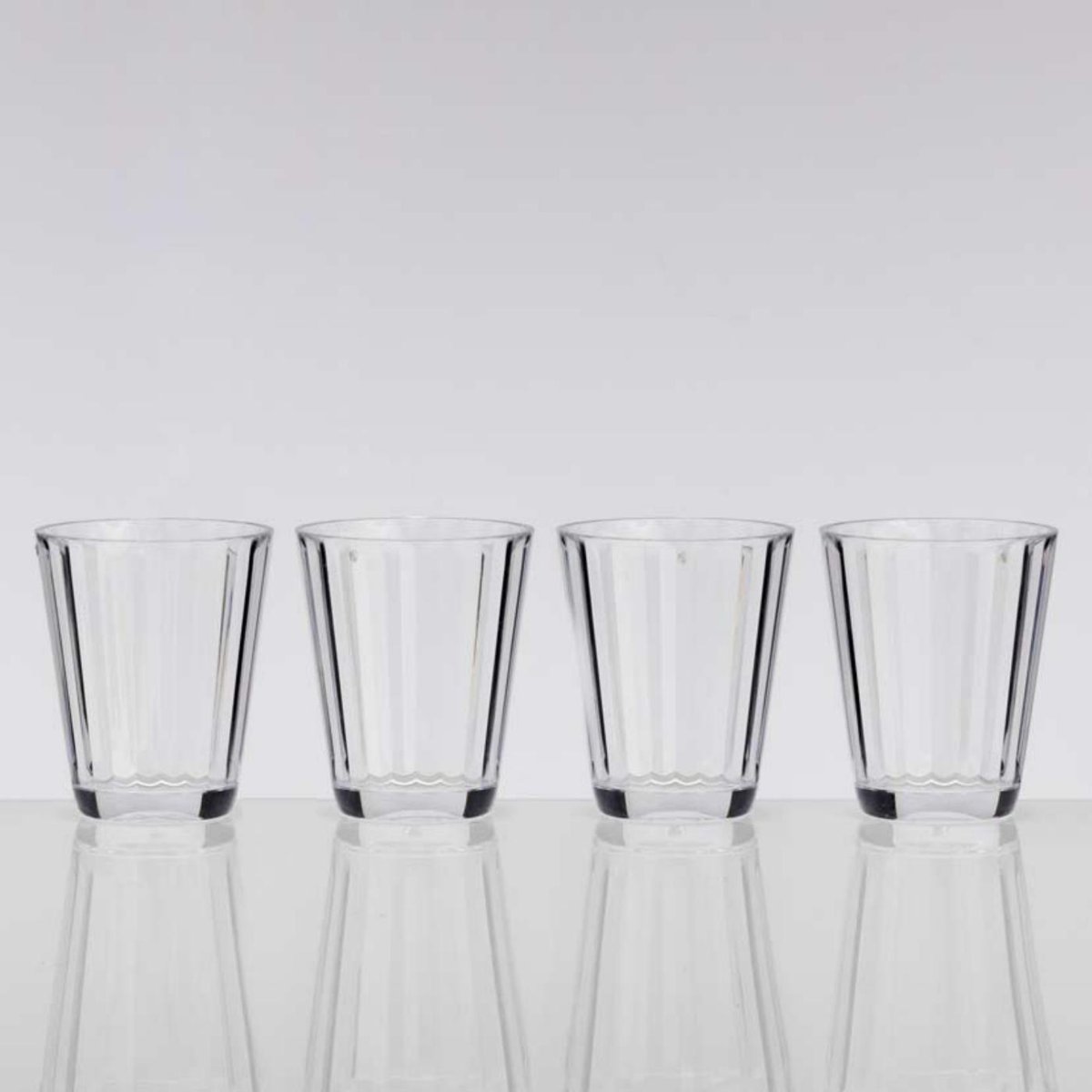 Four short clear faceted tumblers