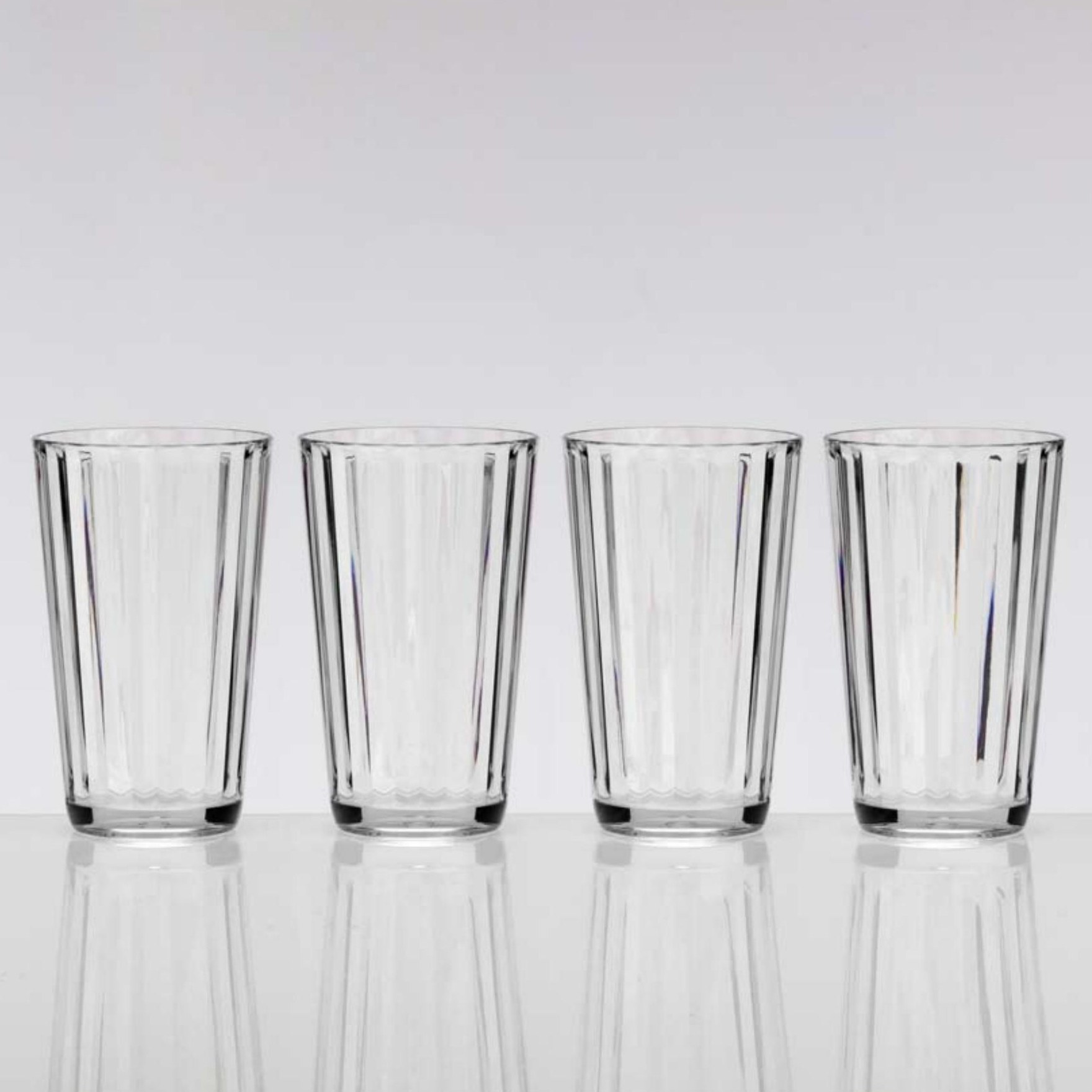Four tall clear drinking glasses